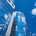 Aluminum facade system CW 50 Alu on steel used on modern glass building with blue sky background.