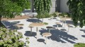 Nordhavn Outdoor Stool | 30 cm in a garden setting.
