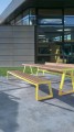 Amager 4 Seater Public Backless Bench with yellow frame in modern outdoor setting.
