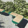 Nordhavn Public Backless Bench in L-shaped design on gravel patio with bushes in background.