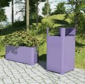 Ørestad Outdoor Planter | 150 l next to a purple outdoor bin on a cobblestone path.