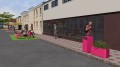 Jardinière d'extérieur Ørestad rose de 150 l sur le trottoir devant un bâtiment moderne.