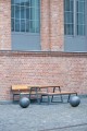 Outdoor seating set featuring Amager Outdoor Table 150 cm with bench, suitable for 4-6 seats, against a brick wall.