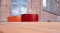 Round red and square orange Valby Public Backless Bench.