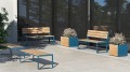 Frederiksberg 3 Seater Public Backrest Bench on a modern outdoor patio with planters.