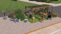 Banc dossier avec accoudoir pour 1 personne Frederiksberg dans un jardin public avec autres meubles de jardin et pergola.