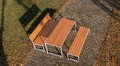 Frederiksberg 4 Seater Public Backless Bench with matching wooden table and bench set in a park.