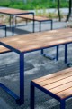 Frederiksberg Outdoor Table 150 cm with blue metal frame set on gravel.