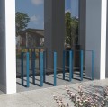 Frederiksberg Bike Stand | 40 cm blue bike racks in front of a modern building.
