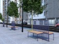 Zweiseitige Bank Østerbro Öffentliche Rückenlehnenbank in städtischer Umgebung mit grünen Bäumen und modernen Gebäuden.
