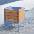 Østerbro Outdoor Stool w/ Planter Box in blue and wood on pavement.
