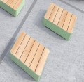 Banc Public Sans Dossier Kødbyen rectangulaire en bois et métal vert sur sol en béton.