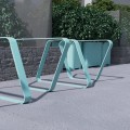 Modern Kødbyen Bike Stand made of turquoise metal, installed outdoors.