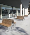 Hellerup 3 Seater Public Backrest Bench outside a modern building.