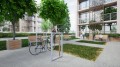 Hellerup Bike Stand | Vertical in a modern urban park setting with benches and trees