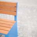 Indre By 3 Seater Public Backrest Bench with blue metal frame and wooden slats.