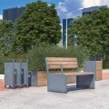 Indre By 3 Seater Public Backrest Bench in an urban park setting with trees and buildings in the background.