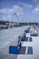Indre By 3 Seater Public Backrest Bench w/ Armrest placed in a public park area with a Ferris wheel in the background