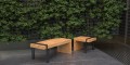 Vesterbro 2 Seater Public Backless Bench in oak with metal frame  placed outdoors.