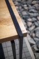 Close-up of the Vesterbro Outdoor Table 180 cm 6-8 Seats | Oak showing the oak tabletop and black metal legs.