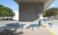 Sydhavn Public Backless Bench | L-shaped under a concrete structure in an outdoor urban area