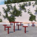 Table de Bar Extérieur Sydhavn rouge avec tabourets intégrés dans un jardin.