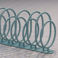 Support à vélos Sydhavn 5 en métal avec des anneaux circulaires alignés sur un sol pavé.