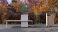 Holmen Bench with integrated planter box in an autumn park.