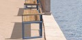 Outdoor modular Christiania 3 Seater Public Backrest Bench with Armrest by the waterfront.