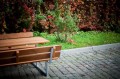 Bench &amp; table (galvanized steel) in garden with autumn foliage.