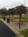 Outdoor Bench &amp; Table (galvanized steel) under pergola in public park.