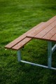 Bench &amp; table (galvanized steel) on green grass.