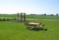 Square Bench &amp; Table set in a grassy outdoor park.
