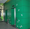 Green HPL PLATE 10 mm panels installed on elevator walls in a commercial building.
