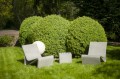 Concrete cube outdoor seating set in garden.