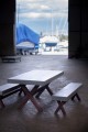 Modern garden set with concrete table and wooden benches in a marina.
