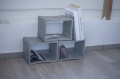 Concrete table used as a bookshelf for magazines.