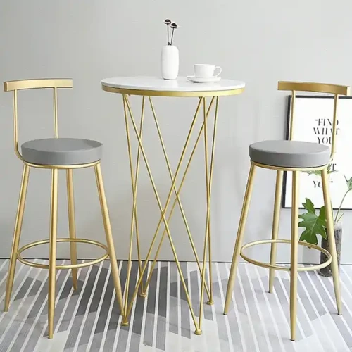 Bar Table Set with two gold stools and a round white table.