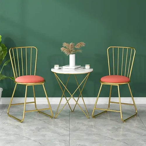 Two Kitchen Furniture Luxury Modern Metal Dining Chairs around a small table with decor items