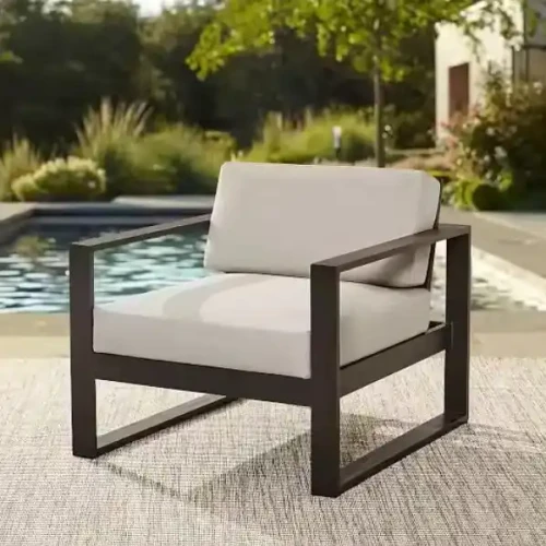Black metal chair with beige cushions for indoor or outdoor decoration.