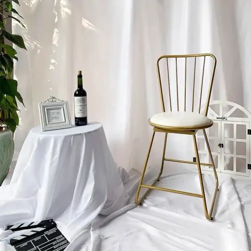 Modern Dining Room Chair with Metal Frame and White Cushion in Decorative Setting