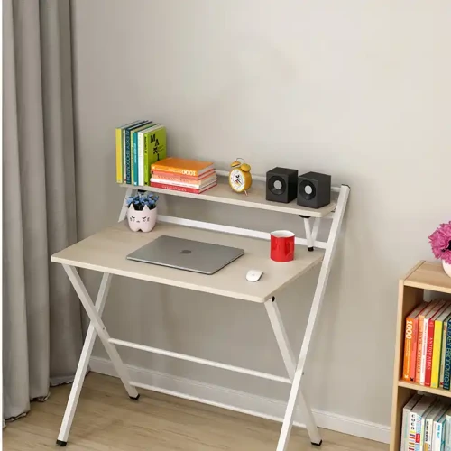 Modern Design Home Indoor Furniture Foldable Metal Study Table in a Living Room with Books, Laptop, and Decorations.