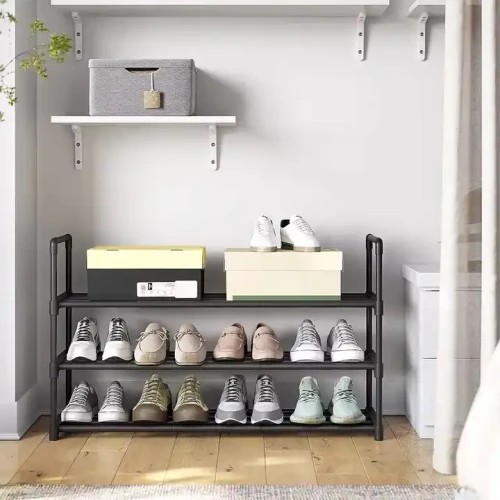 Modern adjustable metal frame shoes rack with extra stackable layer, holding multiple pairs of shoes and shoeboxes in a home entrance.