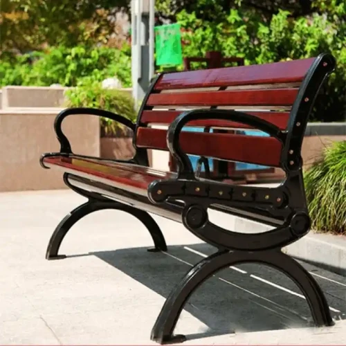 Outdoor garden/patio Furniture metal bench with wood seats in the sun.