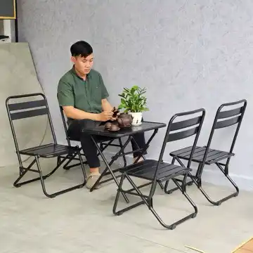 Folding Chair With Simple Design Suitable For All Spaces And Safe For Children, For Garden And Living Home set around a table with a man seated.
