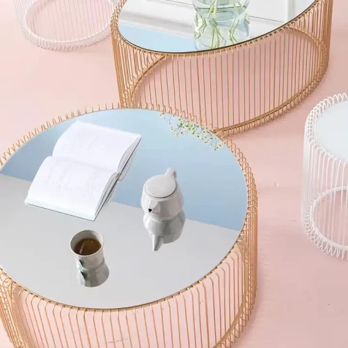 Luxury design metal frame marble top coffee table with open book and tea set on top.