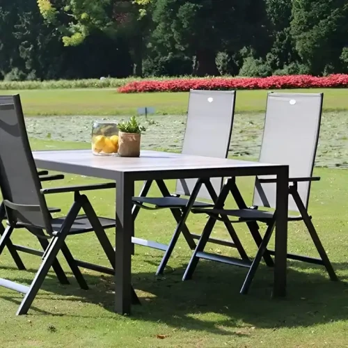 Modern Design Portable Metal Frame Garden Chairs arranged around an outdoor table on a lawn.
