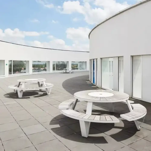 Outdoor patio with Modern Outdoor Dining Set featuring durable metal frame chairs and round wood top table.