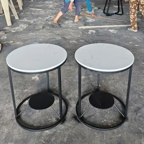 Pair of modern metal tables with white tops.