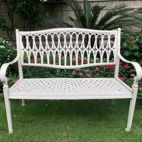 Beautiful metal bench in a garden setting.